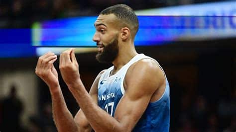 Write informative laconic excerpt under 30 words in mexican spanish for news below. Do not wrap it into quotation marks or html tags. El jugador de baloncesto Rudy Gobert fue transferido de los Jazz a los Timberwolves en un intercambio. Gobert demostró ser un defensor destacado en su etapa con los Jazz, liderando la NBA en bloqueos y rebotes. Se espera que Gobert tenga un papel clave en la defensa de los Timberwolves, pero su producción ofensiva podría verse afectada en comparación con sus años anteriores en los Jazz.,Rudy Gobert traspasado de Jazz a Timberwolves, esperando un rol defensivo crucial pero menor producción ofensiva en nuevo equipo.