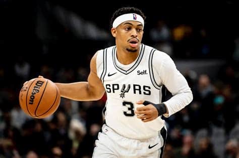 Write informative laconic excerpt under 30 words in mexican spanish for news below. Do not wrap it into quotation marks or html tags. Keldon Johnson, jugador de los San Antonio Spurs, ha visto una disminución en su rendimiento de fantasía en comparación con la temporada pasada, a pesar de promediar 22.0 puntos por juego. El equipo de los Spurs está reconstruyendo su roster alrededor de Victor Wembanyama, lo que ha llevado a una disminución en el rendimiento de Johnson en otras áreas del juego. Aunque su eficiencia ha disminuido, Johnson sigue siendo una fuente confiable de puntos y tiros de tres, lo que lo convierte en una opción sólida en formatos de ligas de fantasía de 12 equipos.,Disminución en desempeño de fantasía para Keldon Johnson de los Spurs mientras el equipo se enfoca en Victor Wembanyama. Sigue siendo opción sólida para puntos y triples.